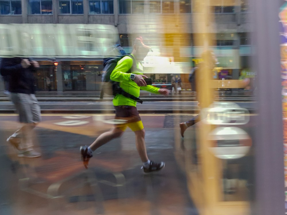 Reflection of a runner in a shop window