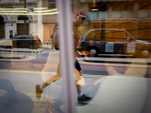 Runner reflected in a shop window